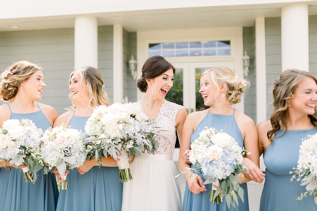 Arielle Peters Photography | Bride and bridesmaids laughing outside at The Blue Heron at Blackthorn in South Bend, Indiana on wedding day.