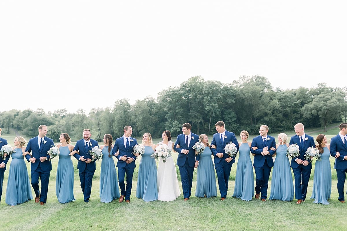 Arielle Peters Photography | Wedding party linking arms outside at The Blue Heron at Blackthorn in South Bend, Indiana on wedding day.