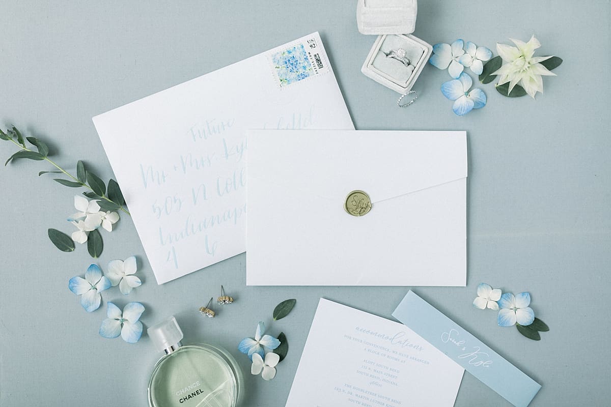 Arielle Peters Photography | Wedding invitation and rings at The Blue Heron at Blackthorn in South Bend, Indiana on wedding day.