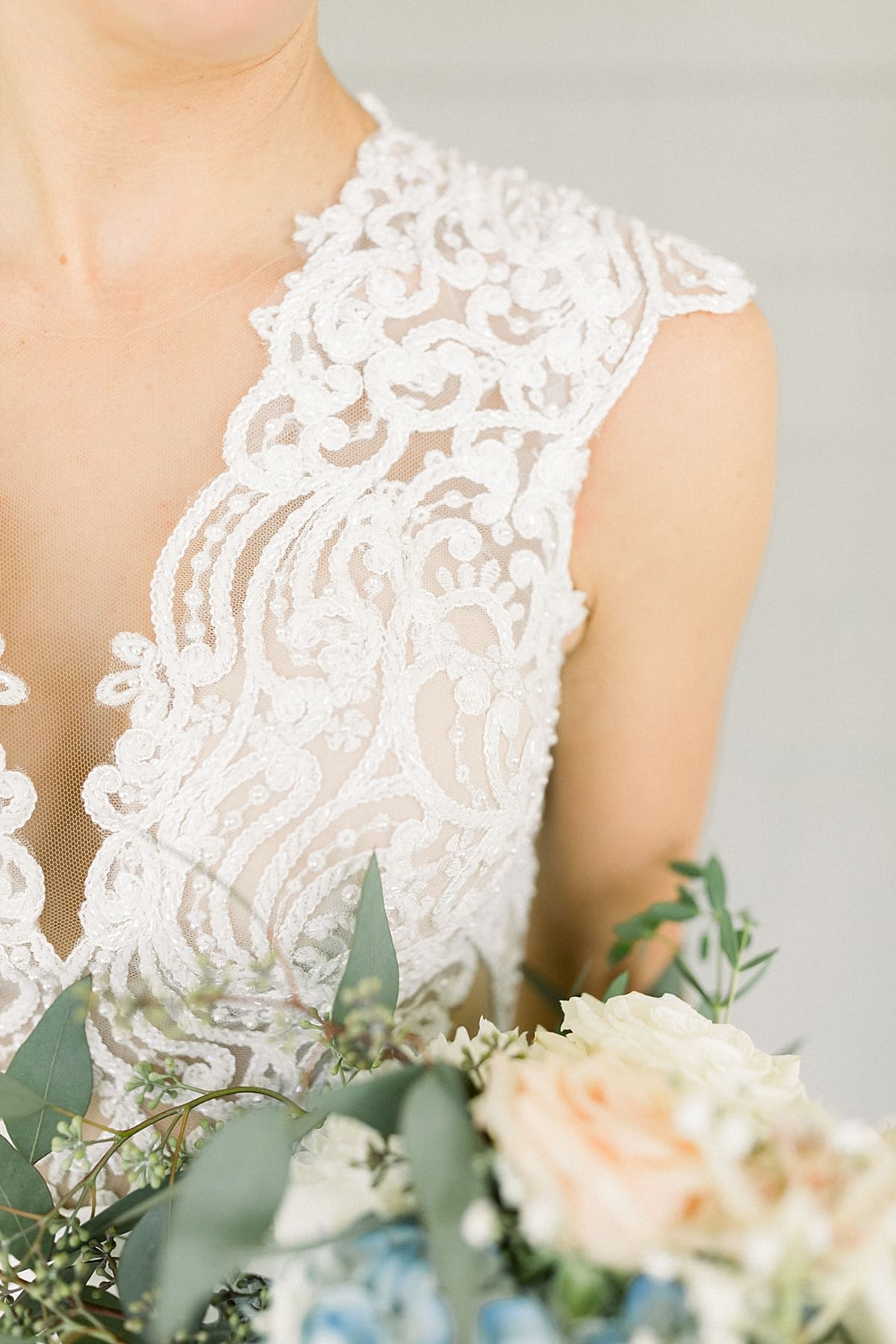 Arielle Peters Photography | Close up of bride's dress and bouquet at The Blue Heron at Blackthorn in South Bend, Indiana on wedding day.