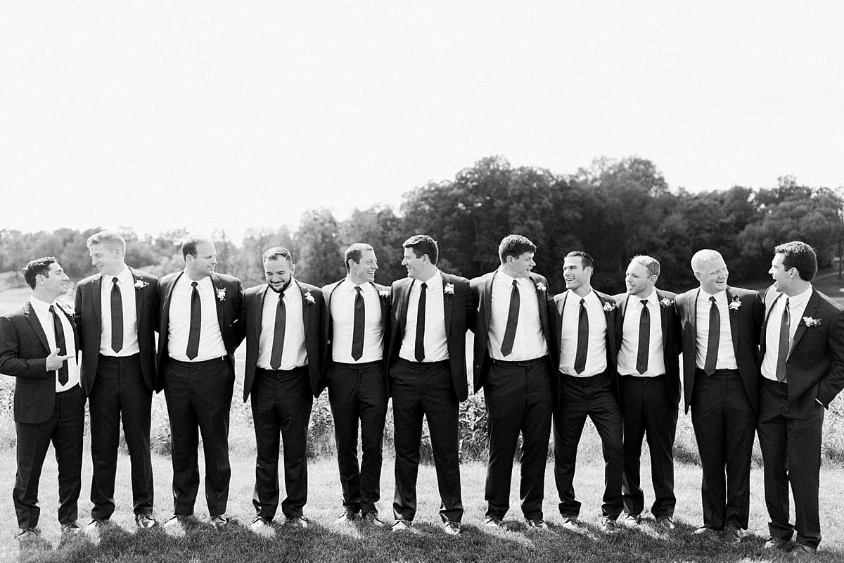 Arielle Peters Photography | Groom and groomsmen lined up outside at The Blue Heron at Blackthorn in South Bend, Indiana on wedding day.