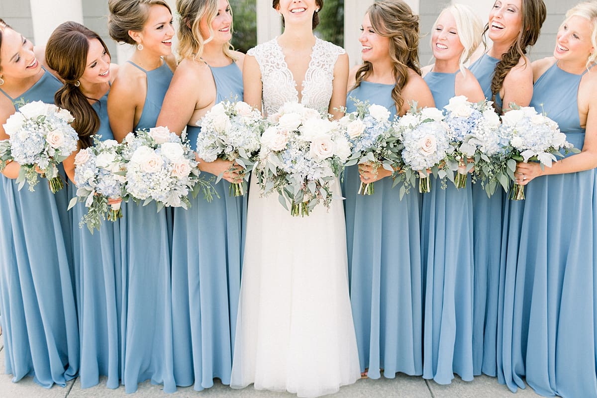 Arielle Peters Photography | Bride and bridesmaids holding bouquets at The Blue Heron at Blackthorn in South Bend, Indiana on wedding day.