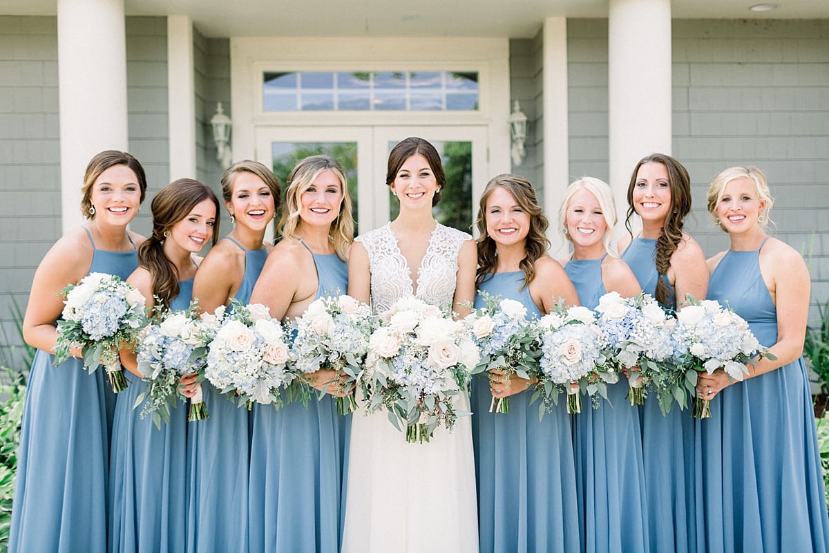 Arielle Peters Photography | Bride and bridesmaids smiling with their bouquets at The Blue Heron at Blackthorn in South Bend, Indiana on wedding day.