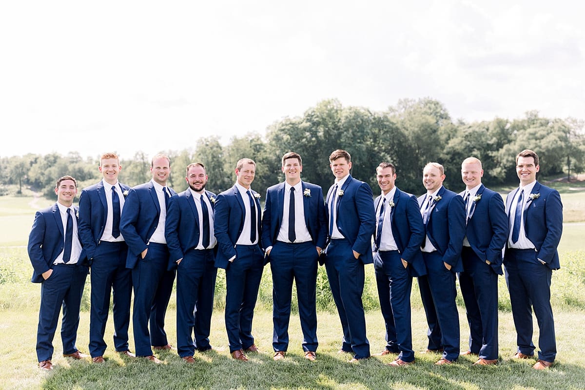 Arielle Peters Photography | Groom and groomsmen with hands in pockets outside at The Blue Heron at Blackthorn in South Bend, Indiana on wedding day.