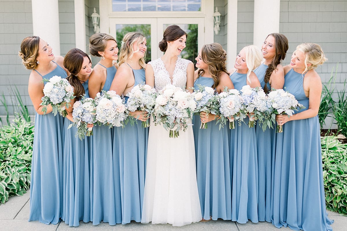 Arielle Peters Photography | Bride and bridesmaids laughing outside at The Blue Heron at Blackthorn in South Bend, Indiana on wedding day.