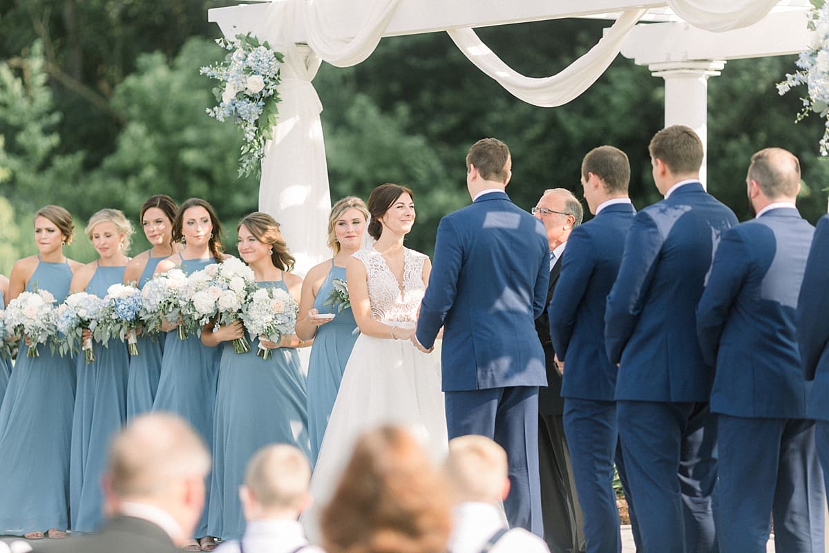Arielle Peters Photography | Bride and groom holding hands at the alter at The Blue Heron at Blackthorn in South Bend, Indiana on wedding day.