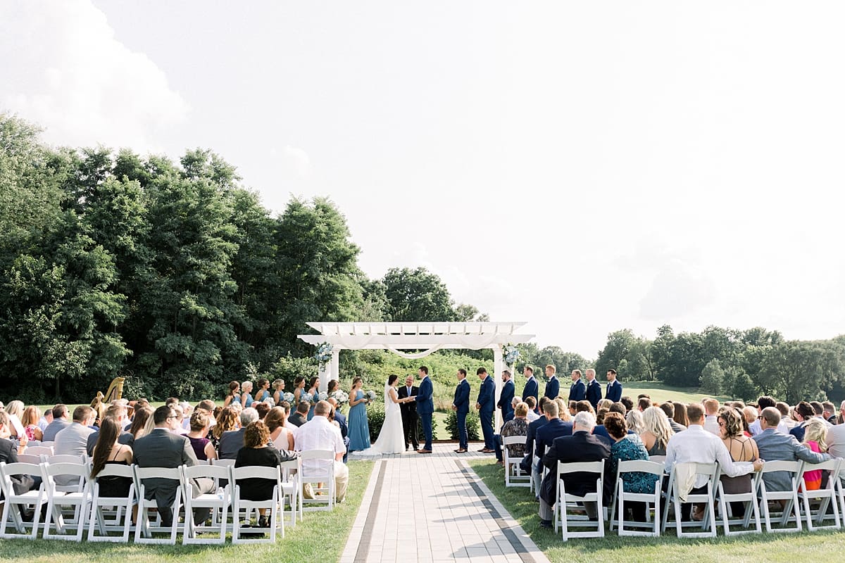 Arielle Peters Photography | Bride and groom holding hands at the alter at The Blue Heron at Blackthorn in South Bend, Indiana on wedding day.