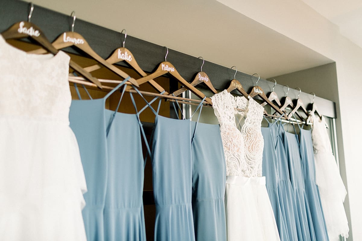 Arielle Peters Photography | Wedding gown hanging next to bridesmaids dresses at The Blue Heron at Blackthorn in South Bend, Indiana on wedding day.