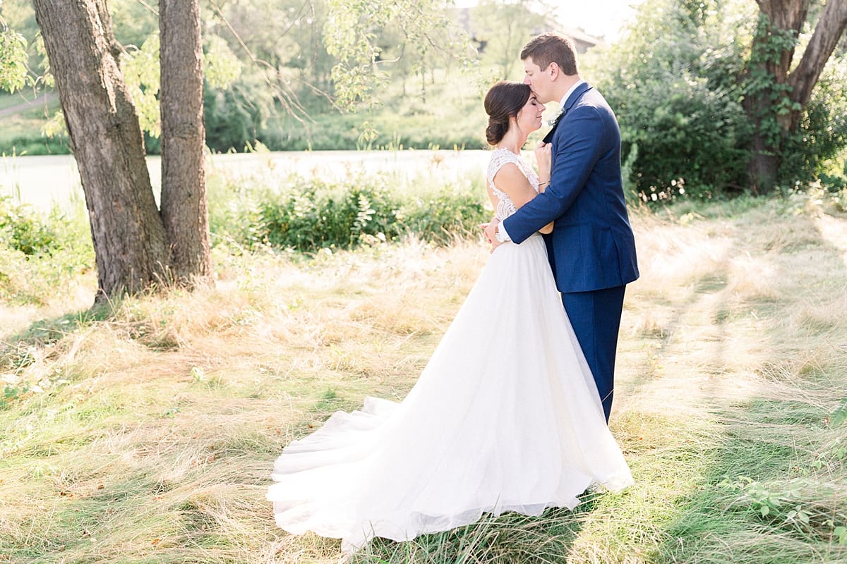 Arielle Peters Photography | Bride and groom kissing outside at The Blue Heron at Blackthorn in South Bend, Indiana on wedding day.