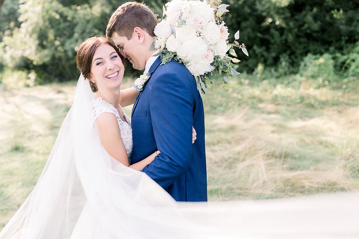 Arielle Peters Photography | Bride and groom kissing outside at The Blue Heron at Blackthorn in South Bend, Indiana on wedding day.