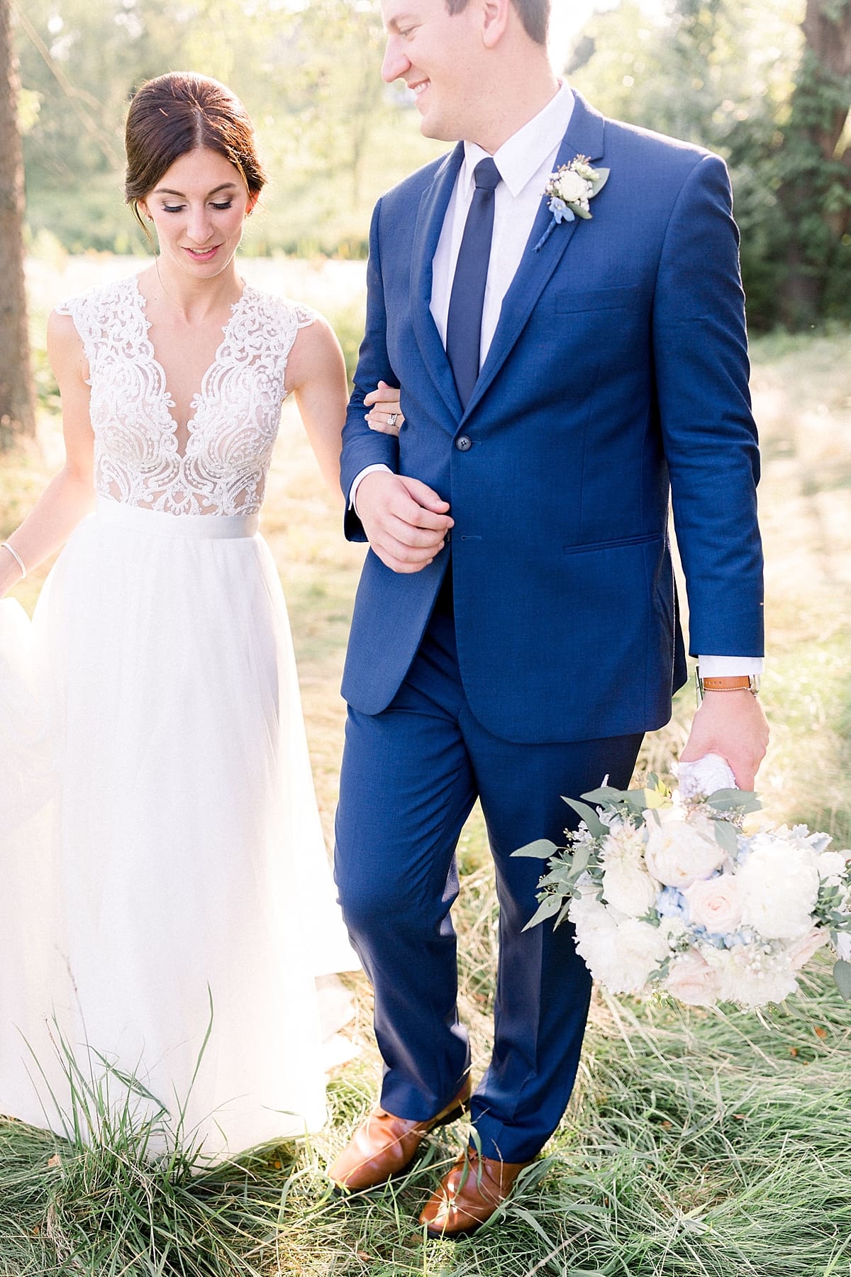 Arielle Peters Photography | Bride and groom walking outside at The Blue Heron at Blackthorn in South Bend, Indiana on wedding day.