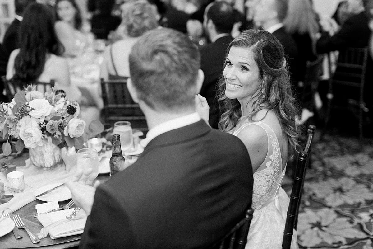 Arielle Peters Photography | Bride and groom smiling at each other at wedding reception at Sycamore Hills Golf Club in Fort Wayne, Indiana on wedding day.