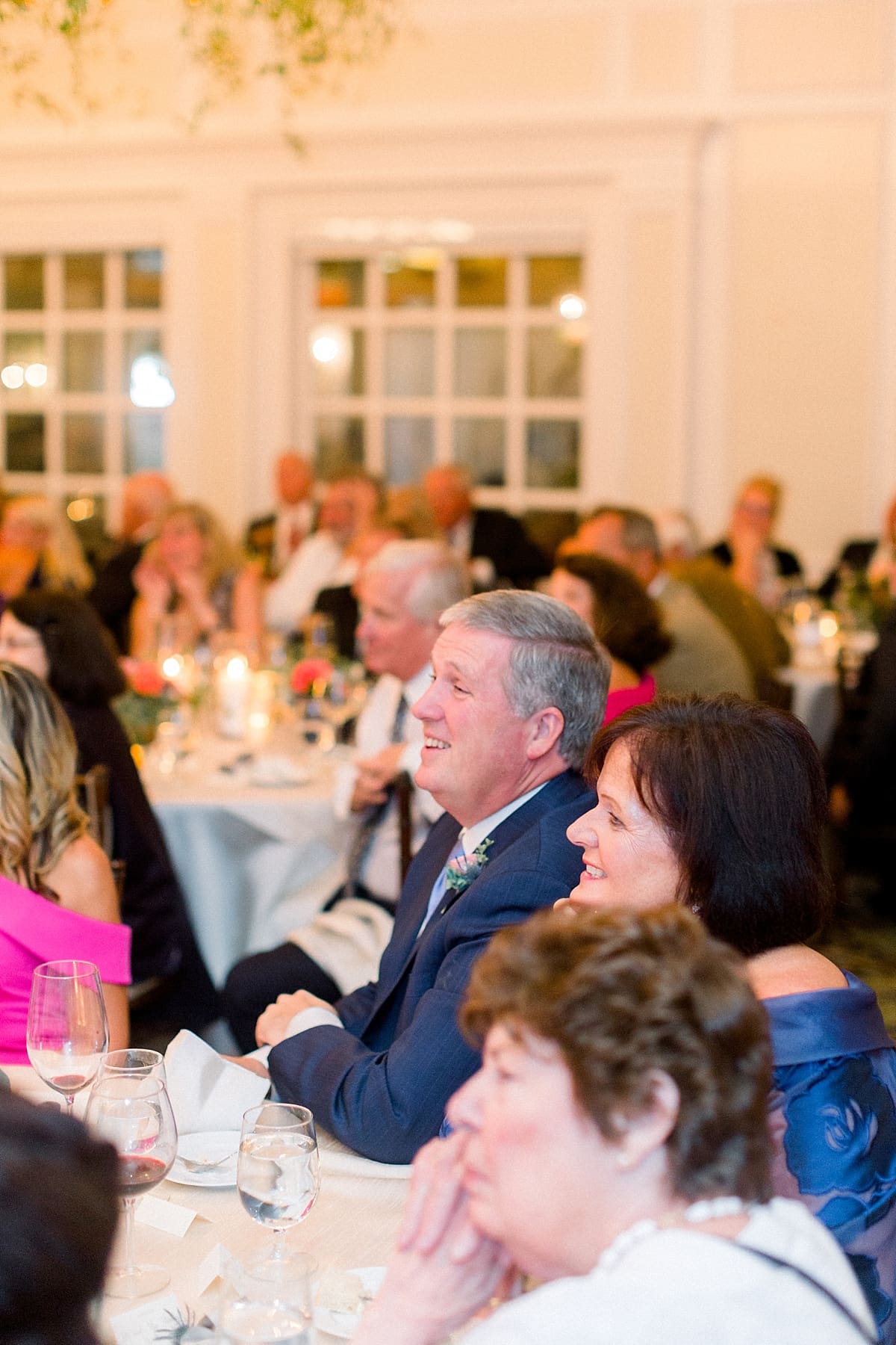 Arielle Peters Photography | Wedding guests laughing at wedding reception at Sycamore Hills Golf Club in Fort Wayne, Indiana on wedding day.