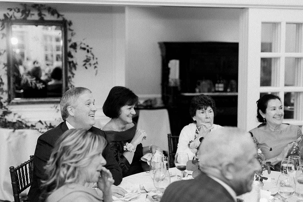 Arielle Peters Photography | Wedding guests laughing at wedding reception at Sycamore Hills Golf Club in Fort Wayne, Indiana on wedding day.