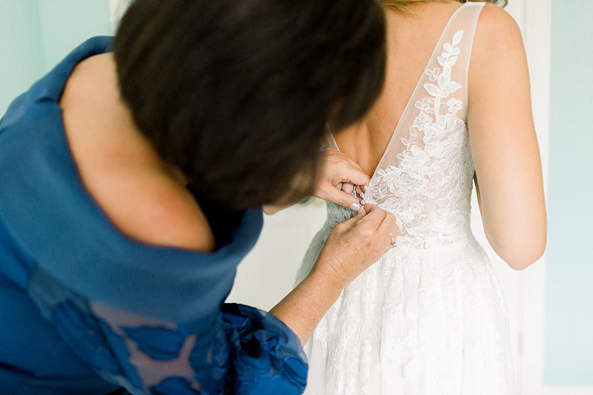 Arielle Peters Photography | Mother of the bride helping dress the bride at Sycamore Hills Golf Club in Fort Wayne, Indiana on wedding day.
