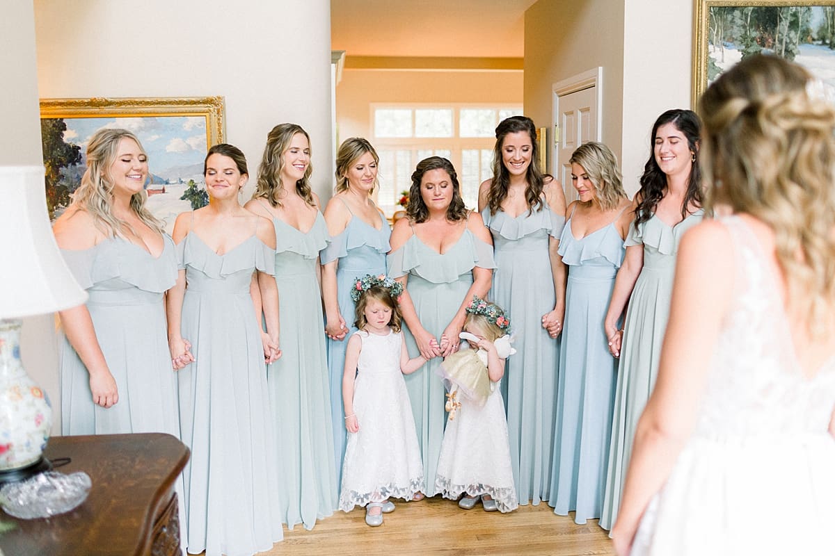 Arielle Peters Photography | Bride revealing wedding gown to bridesmaids at Sycamore Hills Golf Club in Fort Wayne, Indiana on wedding day.