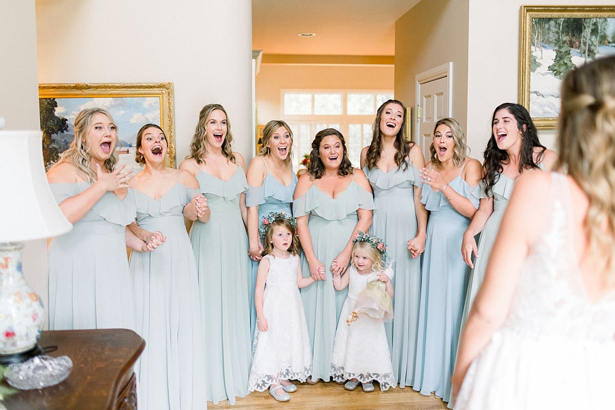 Arielle Peters Photography | Bride revealing wedding gown to bridesmaids at Sycamore Hills Golf Club in Fort Wayne, Indiana on wedding day.