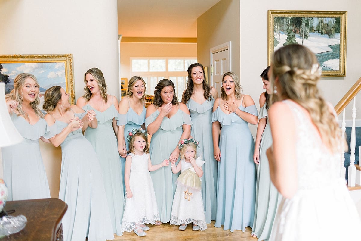 Arielle Peters Photography | Bride revealing wedding gown to bridesmaids at Sycamore Hills Golf Club in Fort Wayne, Indiana on wedding day.
