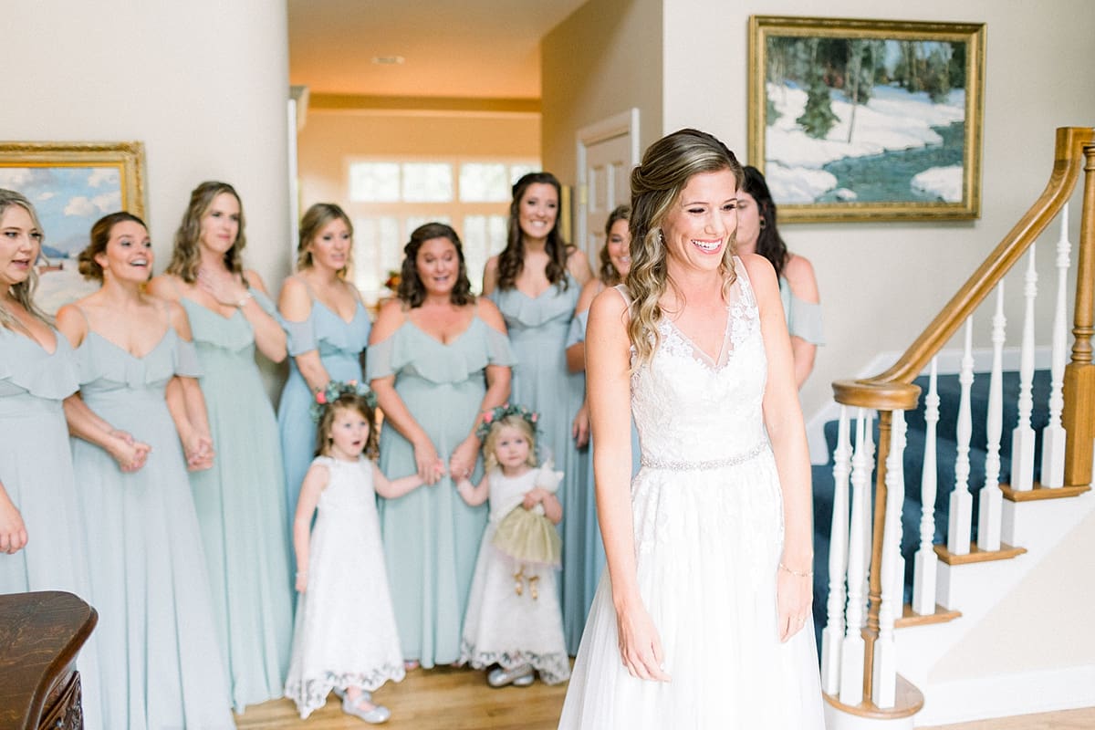 Arielle Peters Photography | Bride revealing wedding gown to bridesmaids at Sycamore Hills Golf Club in Fort Wayne, Indiana on wedding day.