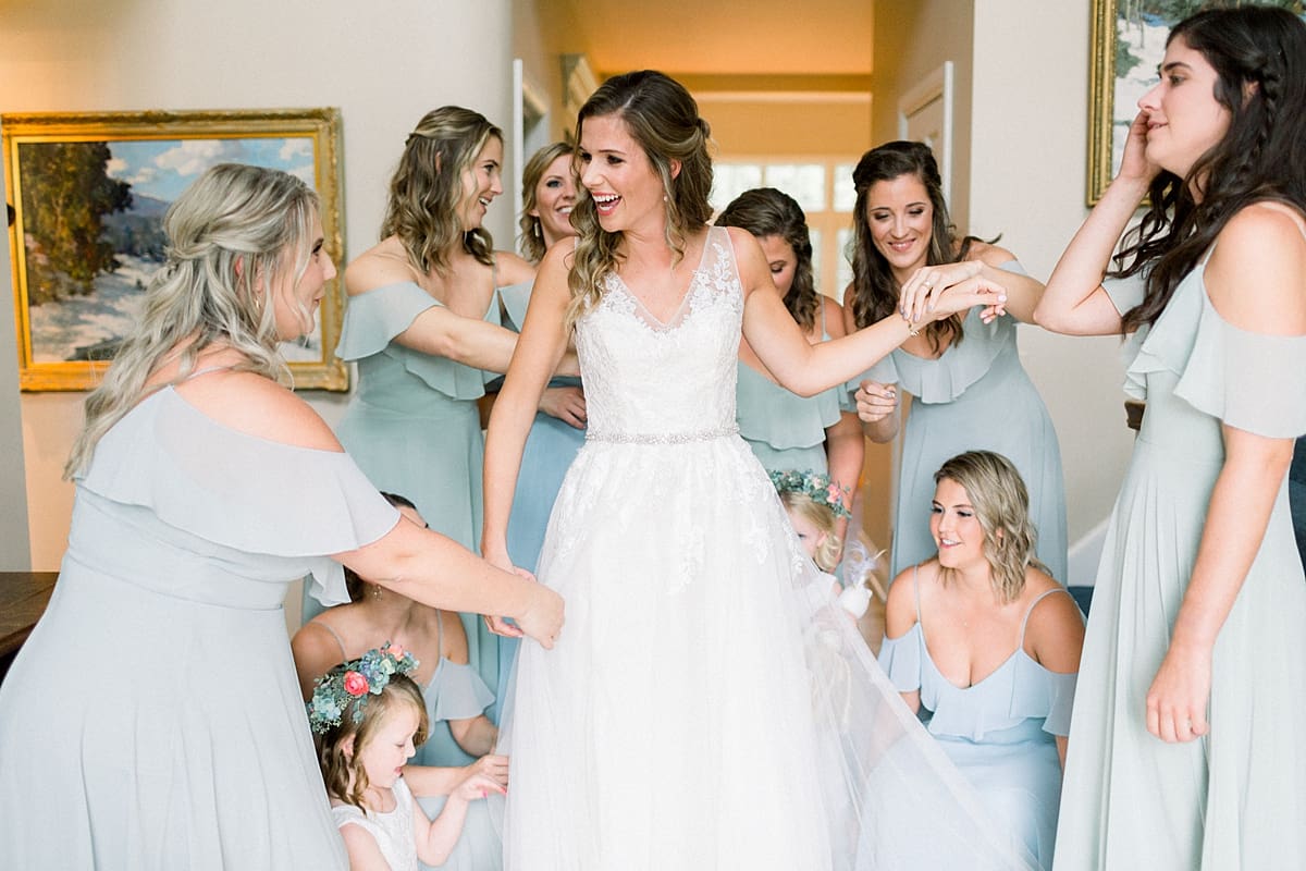 Arielle Peters Photography | Bride revealing wedding gown to bridesmaids at Sycamore Hills Golf Club in Fort Wayne, Indiana on wedding day.
