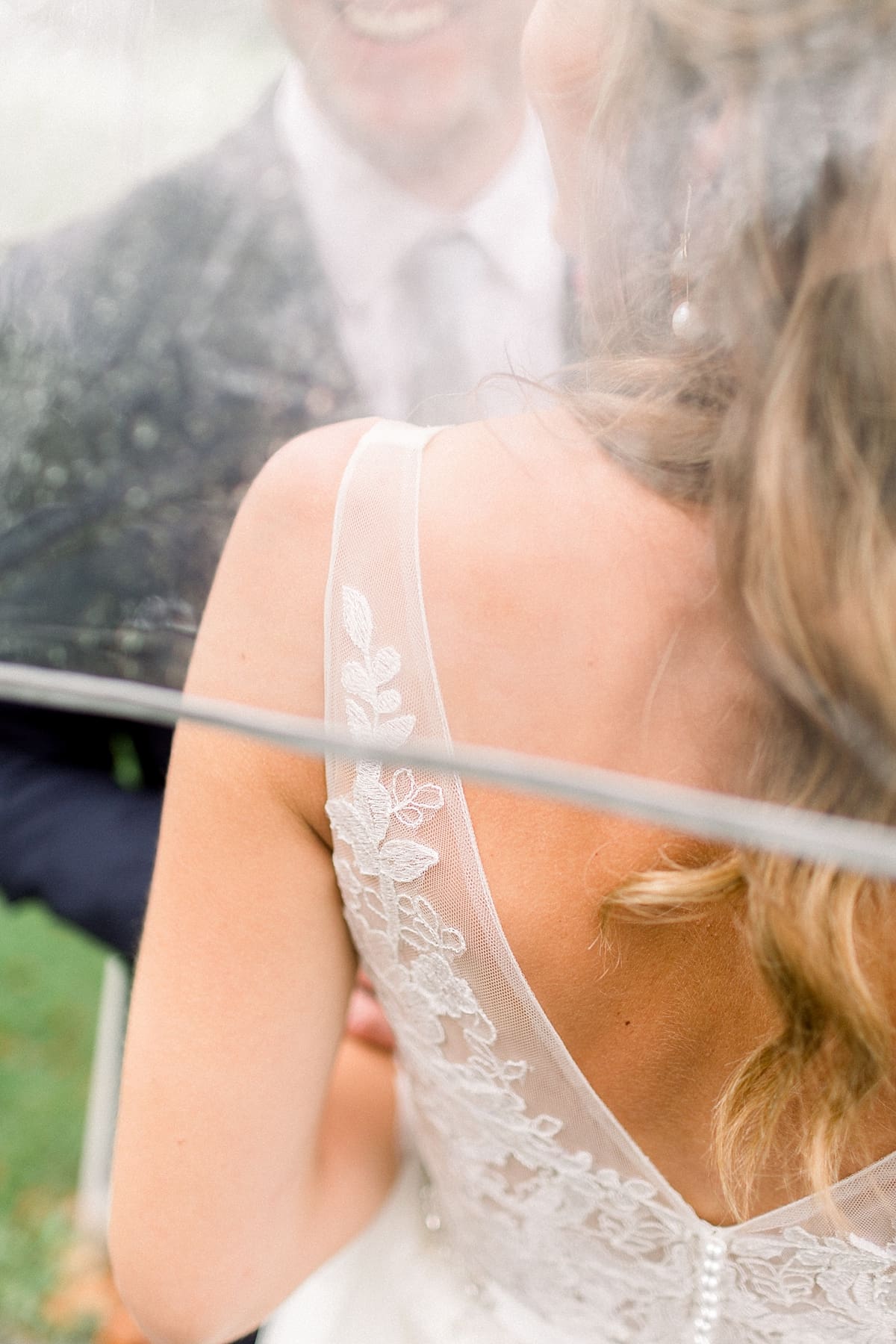 Arielle Peters Photography | Bride and groom outside under umbrella in the rain on wedding day at Sycamore Hills Golf Club in Fort Wayne, Indiana.