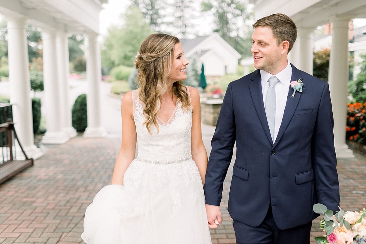 Arielle Peters Photography | Bride and groom holding hands outside on wedding day at Sycamore Hills Golf Club in Fort Wayne, Indiana.