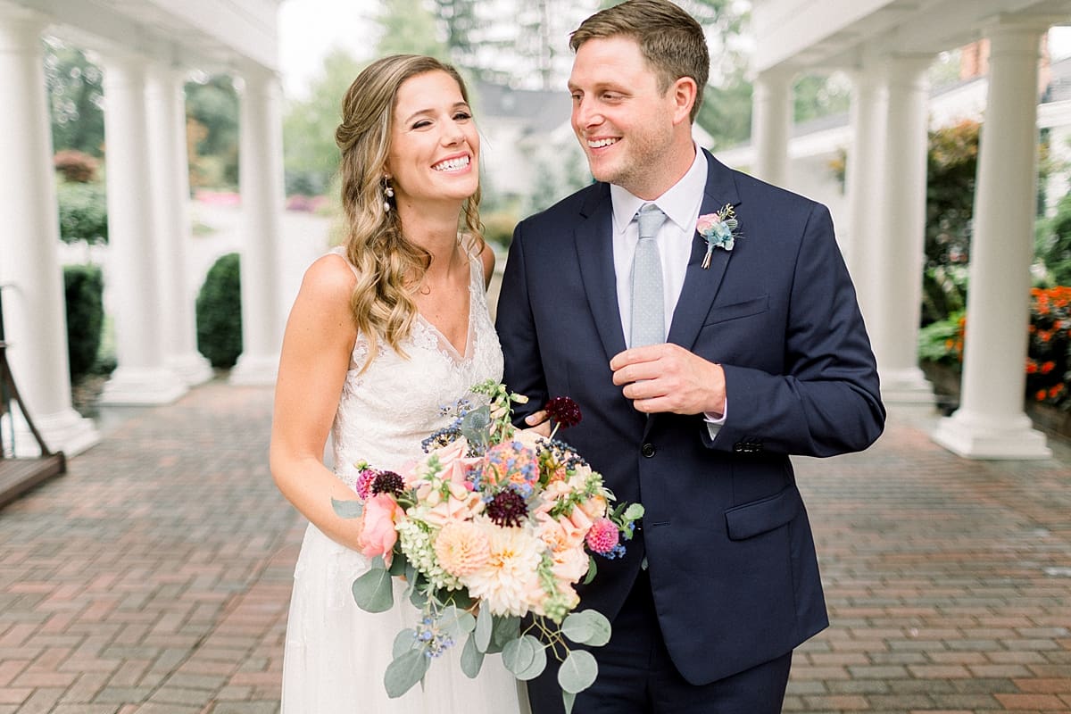 Arielle Peters Photography | Bride and groom laughing outside on wedding day at Sycamore Hills Golf Club in Fort Wayne, Indiana.