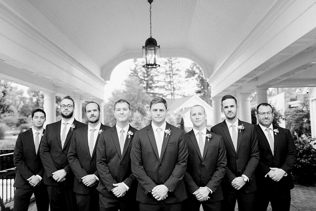 Arielle Peters Photography | Groom and groomsmen with serious faces outside on wedding day at Sycamore Hills Golf Club in Fort Wayne, Indiana.
