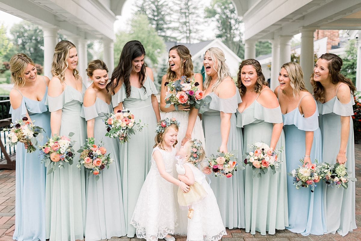 Arielle Peters Photography | Bride and bridesmaids laughing outside on wedding day at Sycamore Hills Golf Club in Fort Wayne, Indiana.