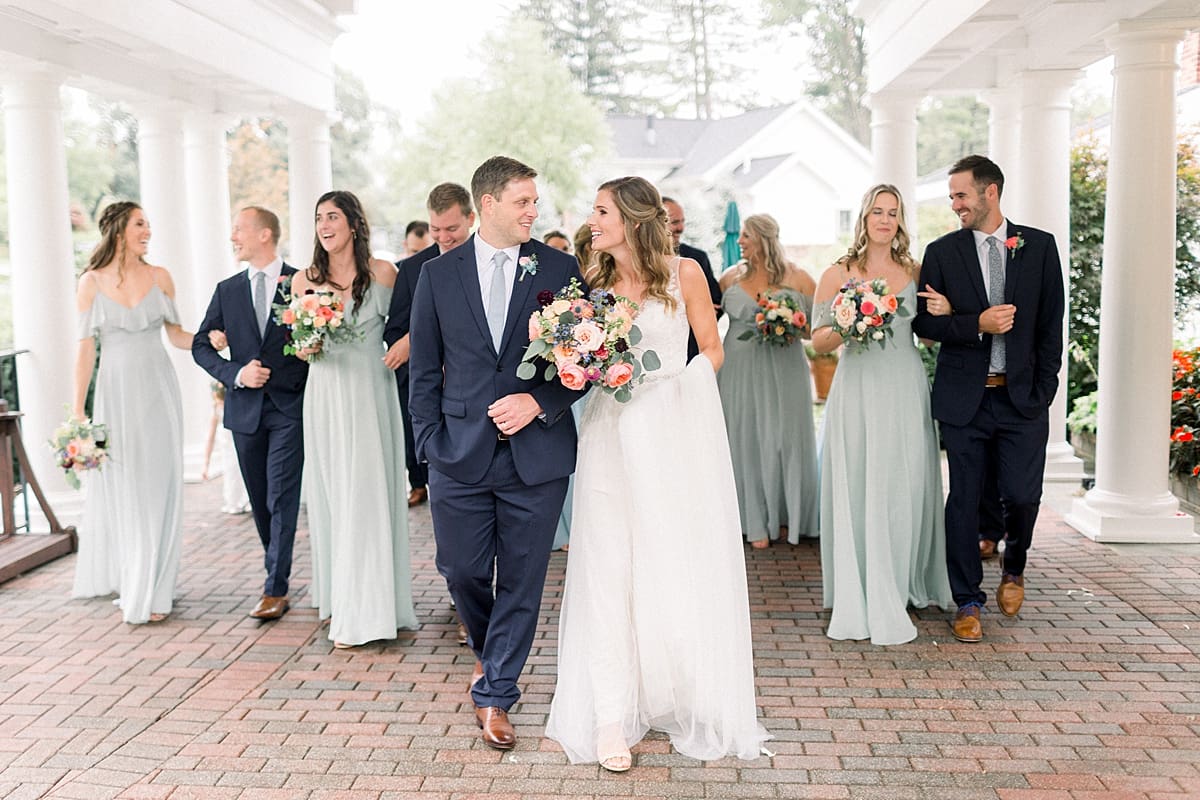 Arielle Peters Photography | Bride and groom walking with wedding party outside on wedding day at Sycamore Hills Golf Club in Fort Wayne, Indiana.