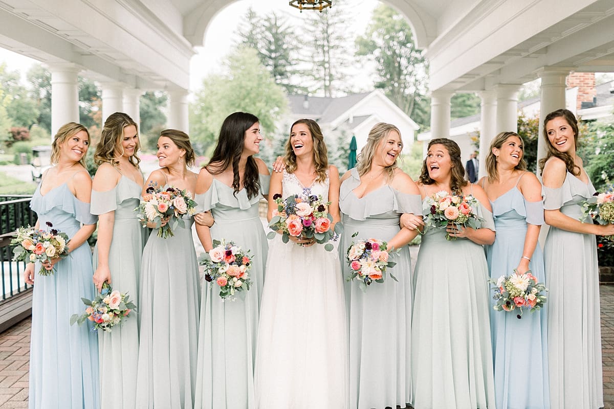 Arielle Peters Photography | Bride and bridesmaids laughing outside on wedding day at Sycamore Hills Golf Club in Fort Wayne, Indiana.