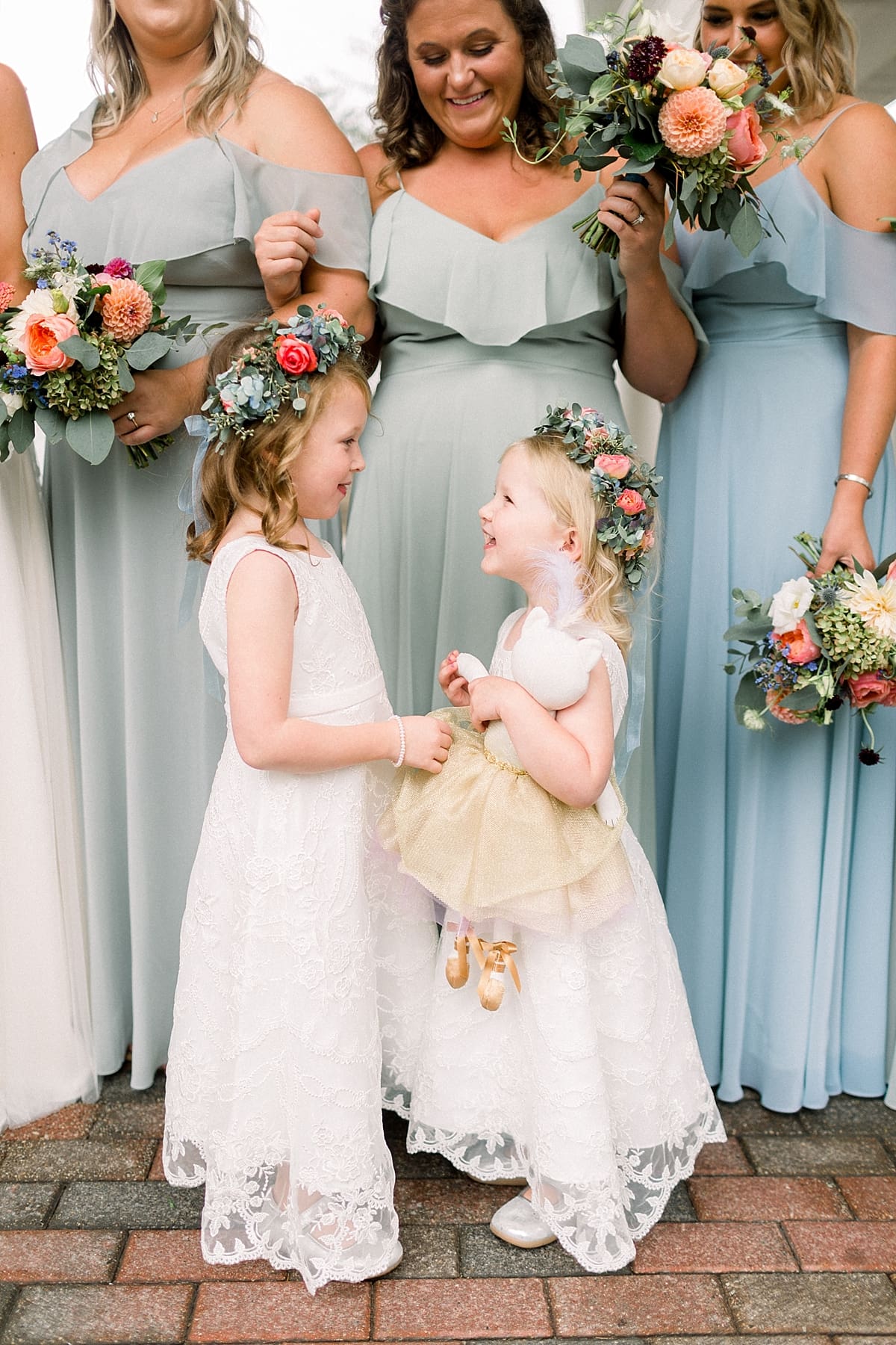 Arielle Peters Photography | Flower girls laughing with bridesmaids outside on wedding day at Sycamore Hills Golf Club in Fort Wayne, Indiana.