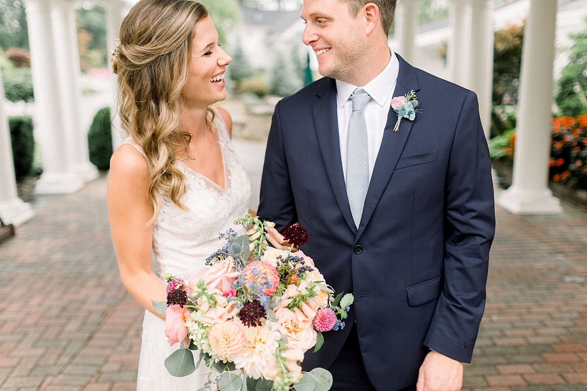 Arielle Peters Photography | Bride and groom laughing outside on wedding day at Sycamore Hills Golf Club in Fort Wayne, Indiana.
