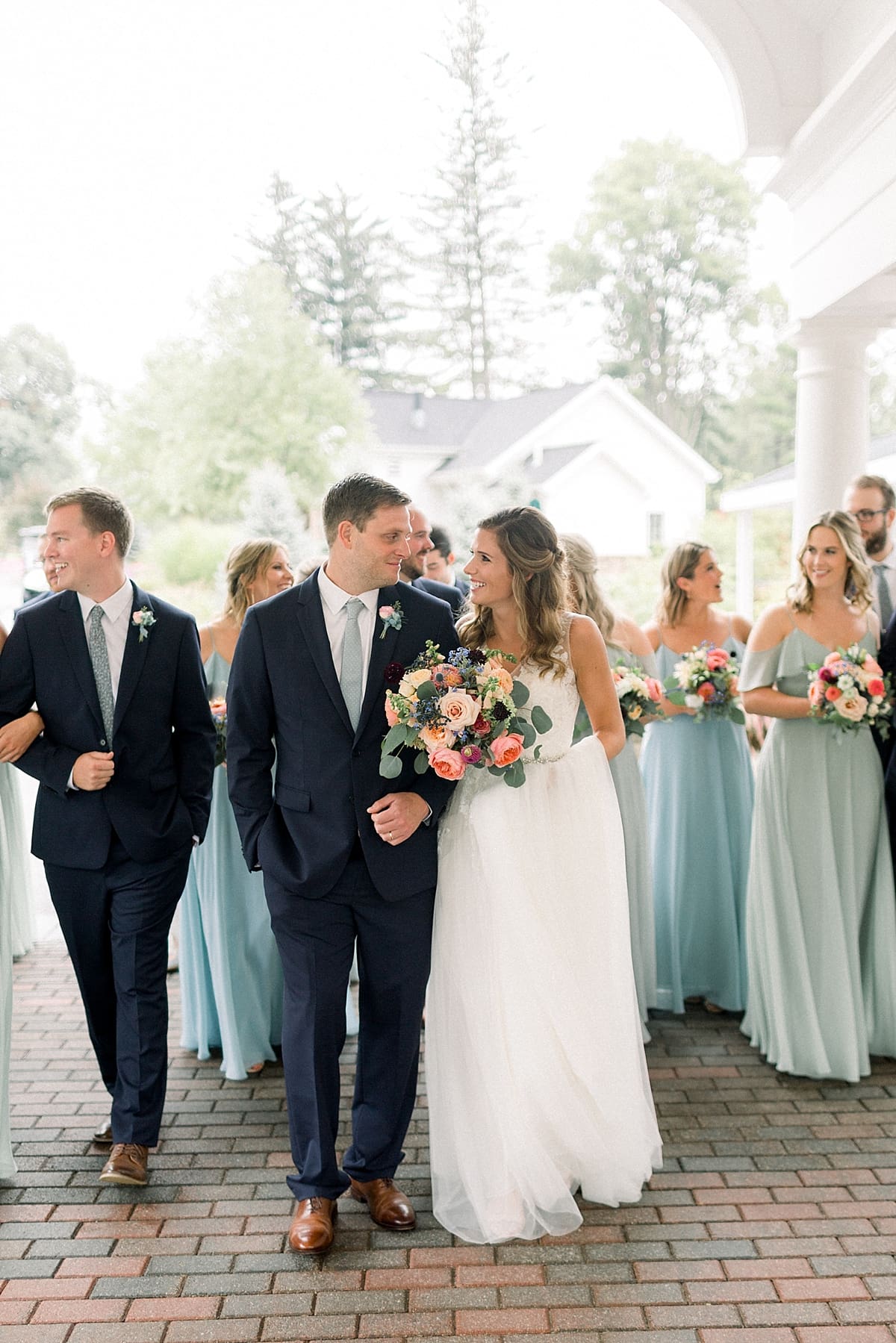 Arielle Peters Photography | Bride and groom linking arms and walking on wedding day at Sycamore Hills Golf Club in Fort Wayne, Indiana.