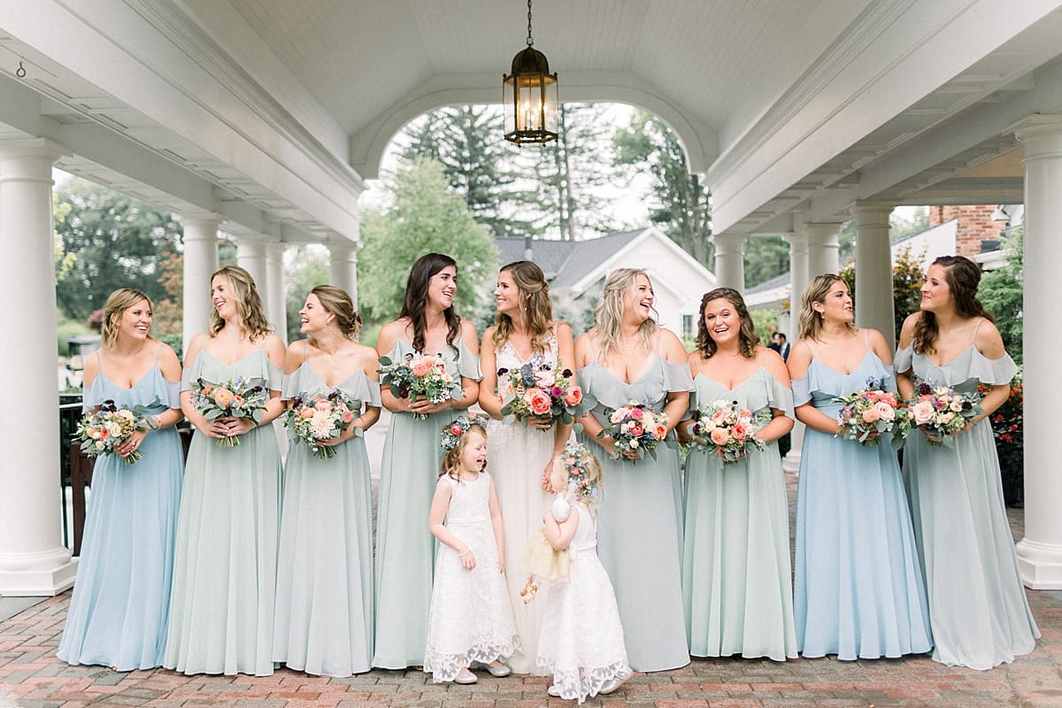 Arielle Peters Photography | Bride and bridesmaids holding bouquets outside on wedding day at Sycamore Hills Golf Club in Fort Wayne, Indiana.