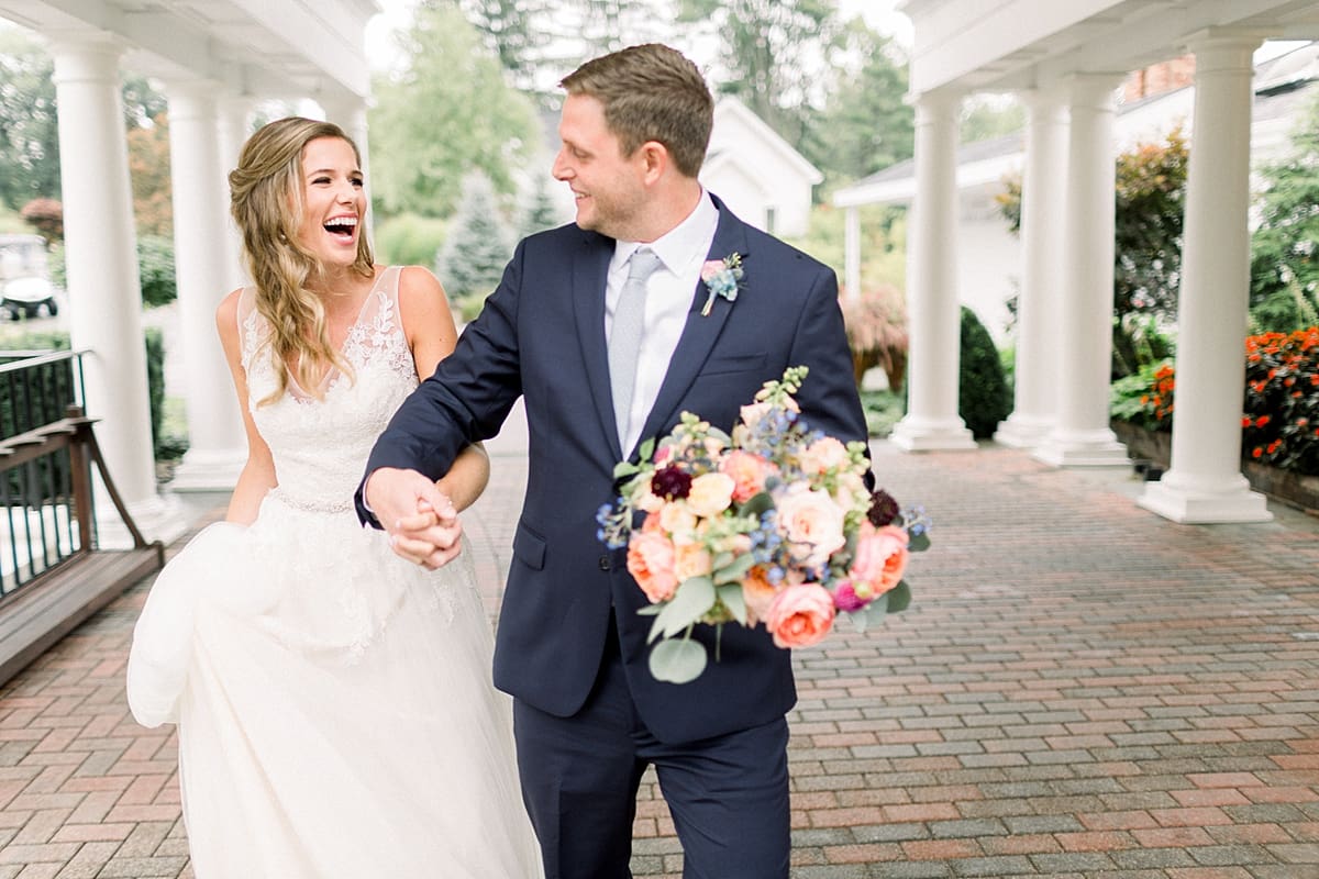 Arielle Peters Photography | Bride and groom holding hands outside on wedding day at Sycamore Hills Golf Club in Fort Wayne, Indiana.