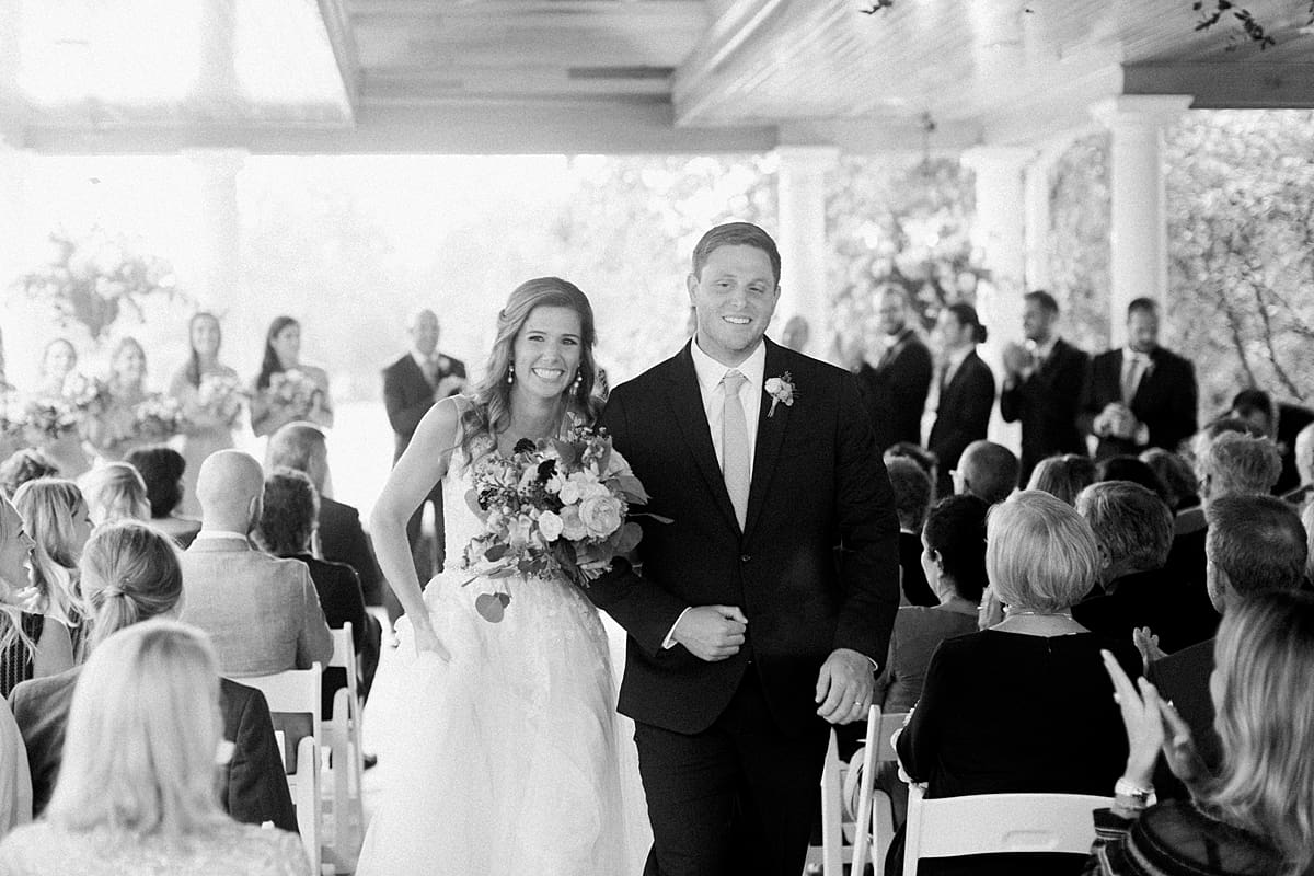 Arielle Peters Photography | Bride and groom walking down the aisle at Sycamore Hills Golf Club in Fort Wayne, Indiana on wedding day.