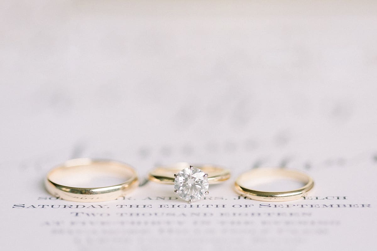 Arielle Peters Photography | Wedding rings on wedding invitation at Sycamore Hills Golf Club in Fort Wayne, Indiana on wedding day.