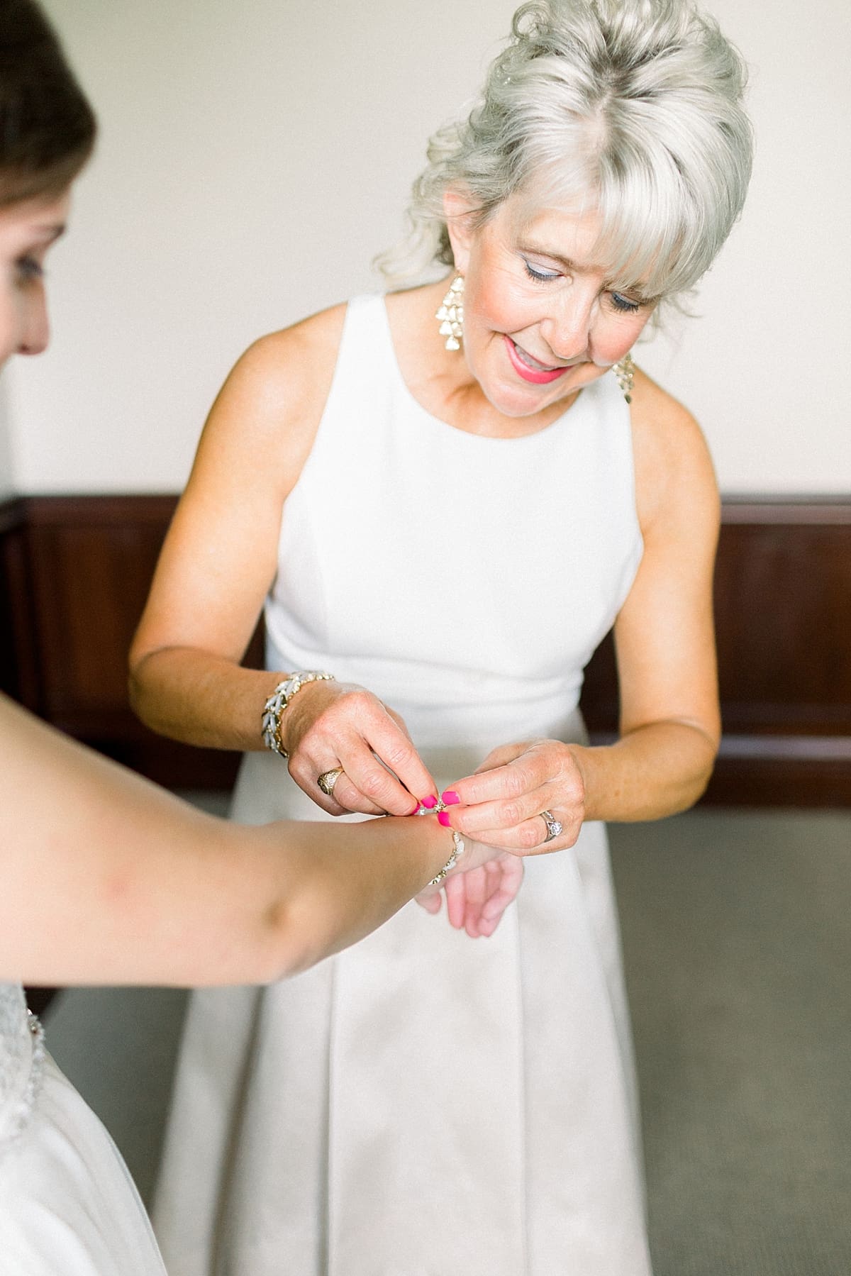 Arielle Peters Photography | Mother of the bride helping the bride get ready at The Bridgewater Club in Carmel, Indiana on wedding day.