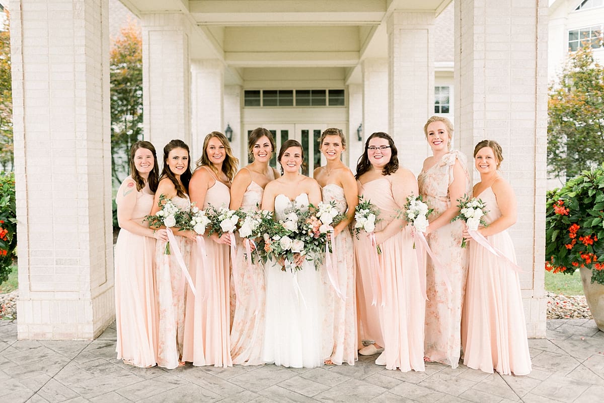 Arielle Peters Photography | Bride and bridesmaids smiling outside at The Bridgewater Club in Carmel, Indiana on wedding day.
