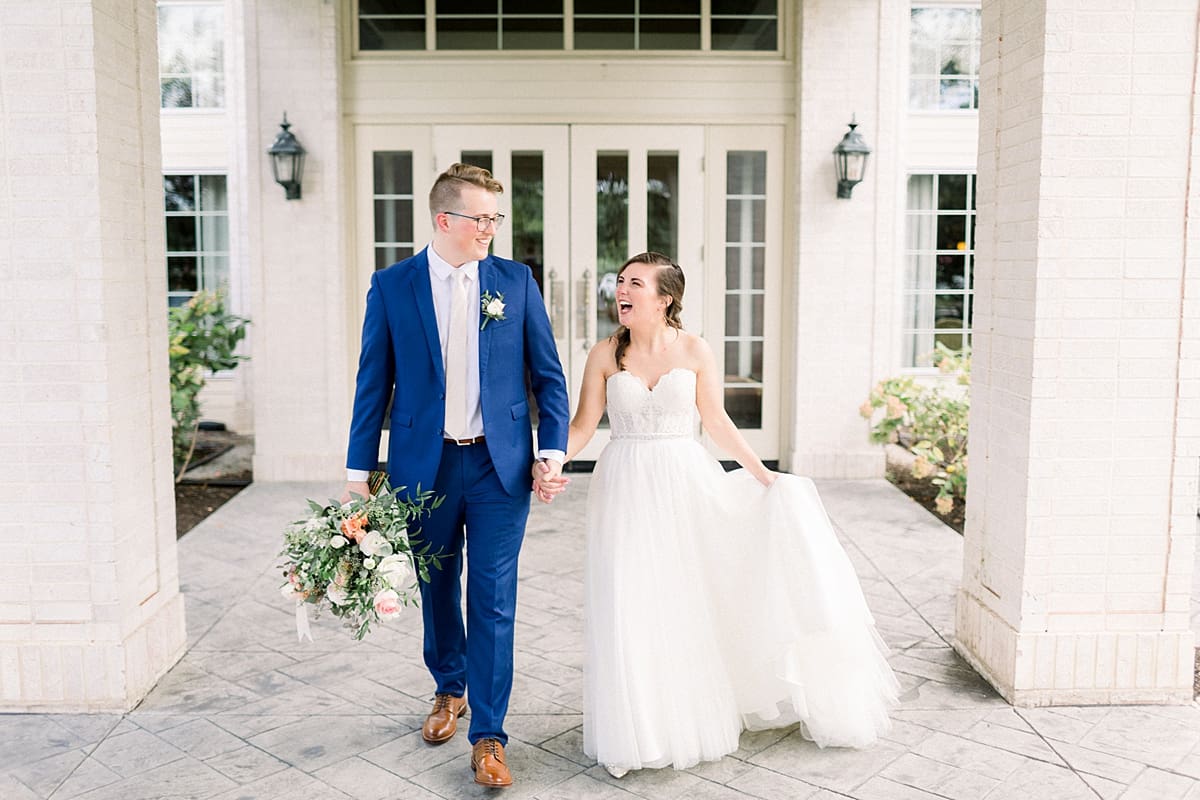 Arielle Peters Photography | Bride and groom smiling and walking outside at The Bridgewater Club in Carmel, Indiana on wedding day.