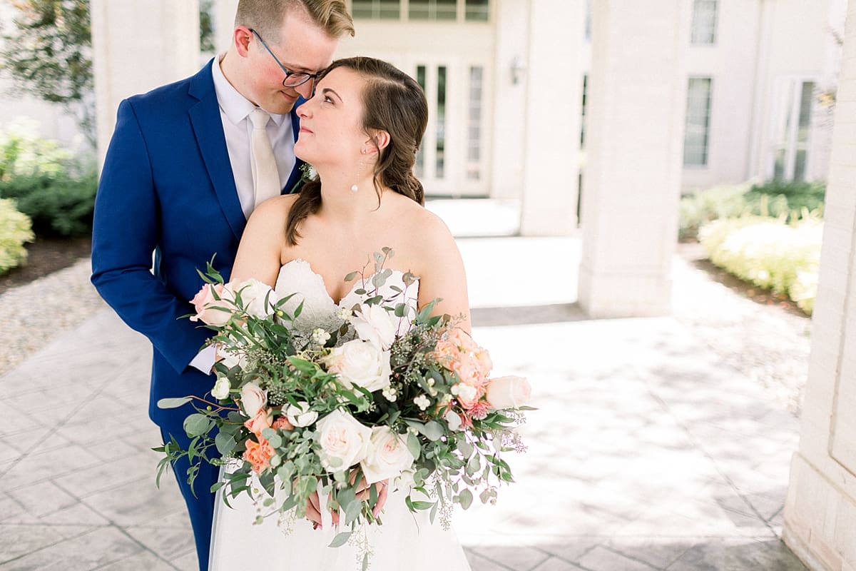 Arielle Peters Photography | Bride and groom smiling at each other outside at The Bridgewater Club in Carmel, Indiana on wedding day.