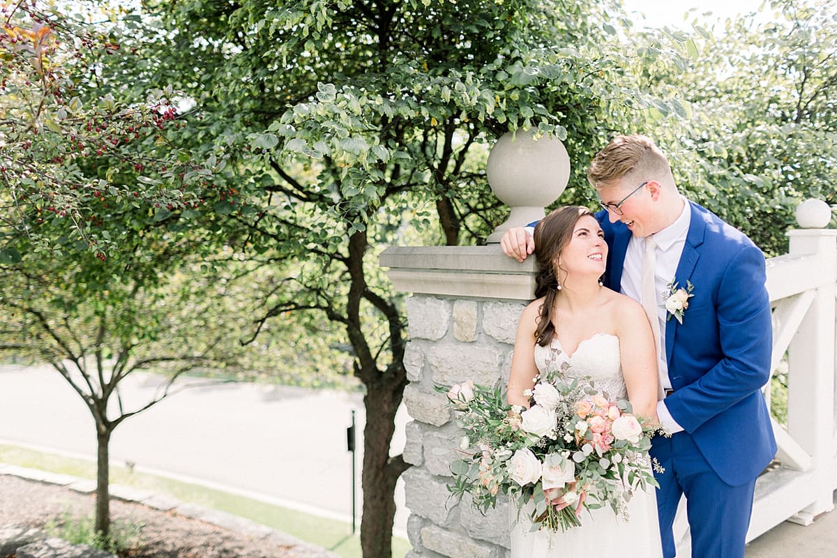 Arielle Peters Photography | Bride and groom smiling at each other outside at The Bridgewater Club in Carmel, Indiana on wedding day.