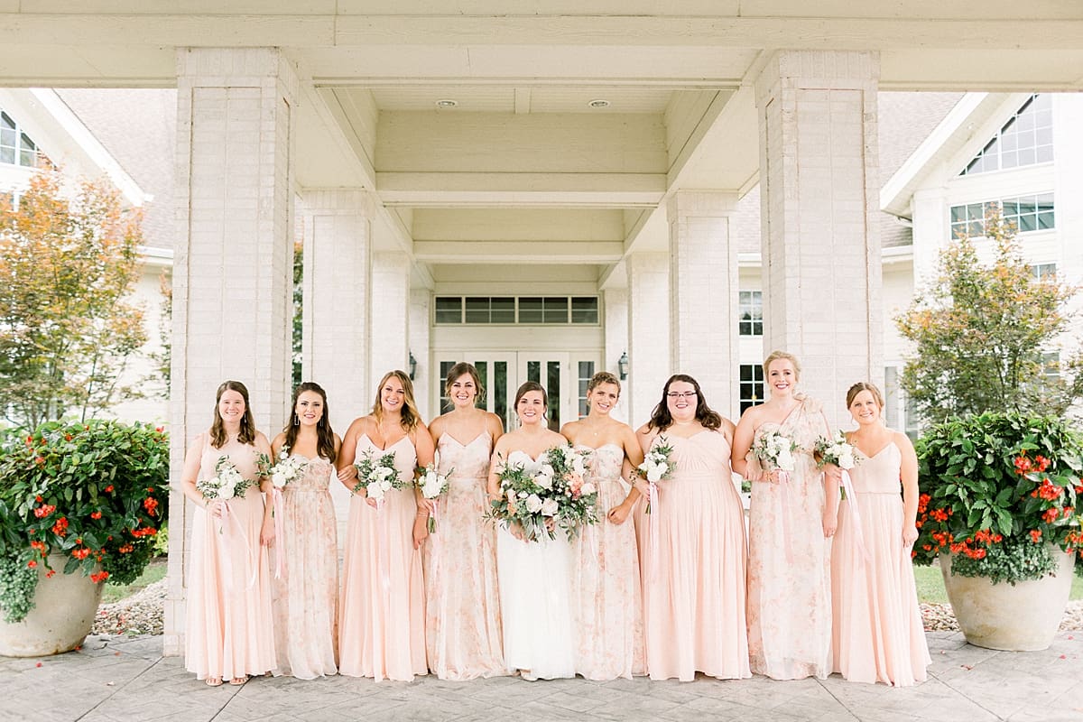 Arielle Peters Photography | Bride and bridesmaids smiling outside at The Bridgewater Club in Carmel, Indiana on wedding day.