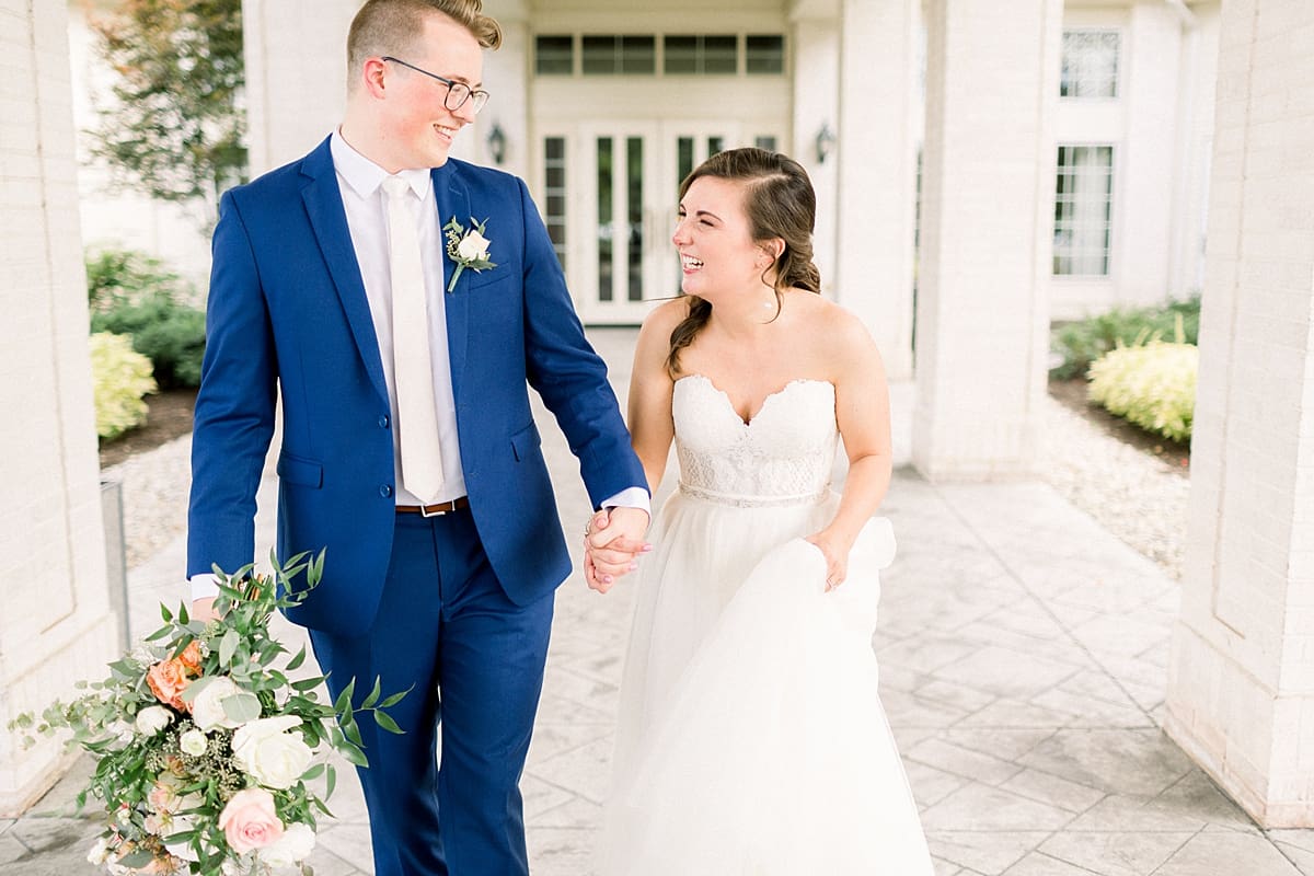 Arielle Peters Photography | Bride and groom smiling at each other outside at The Bridgewater Club in Carmel, Indiana on wedding day.