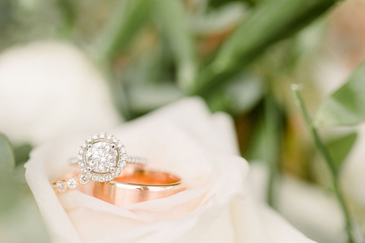Arielle Peters Photography | Wedding rings stacked on roses at The Bridgewater Club in Carmel, Indiana on wedding day.