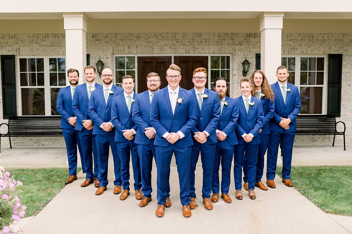 Arielle Peters Photography | Groom and groomsmen smiling outside in their tuxes at The Bridgewater Club in Carmel, Indiana on wedding day.