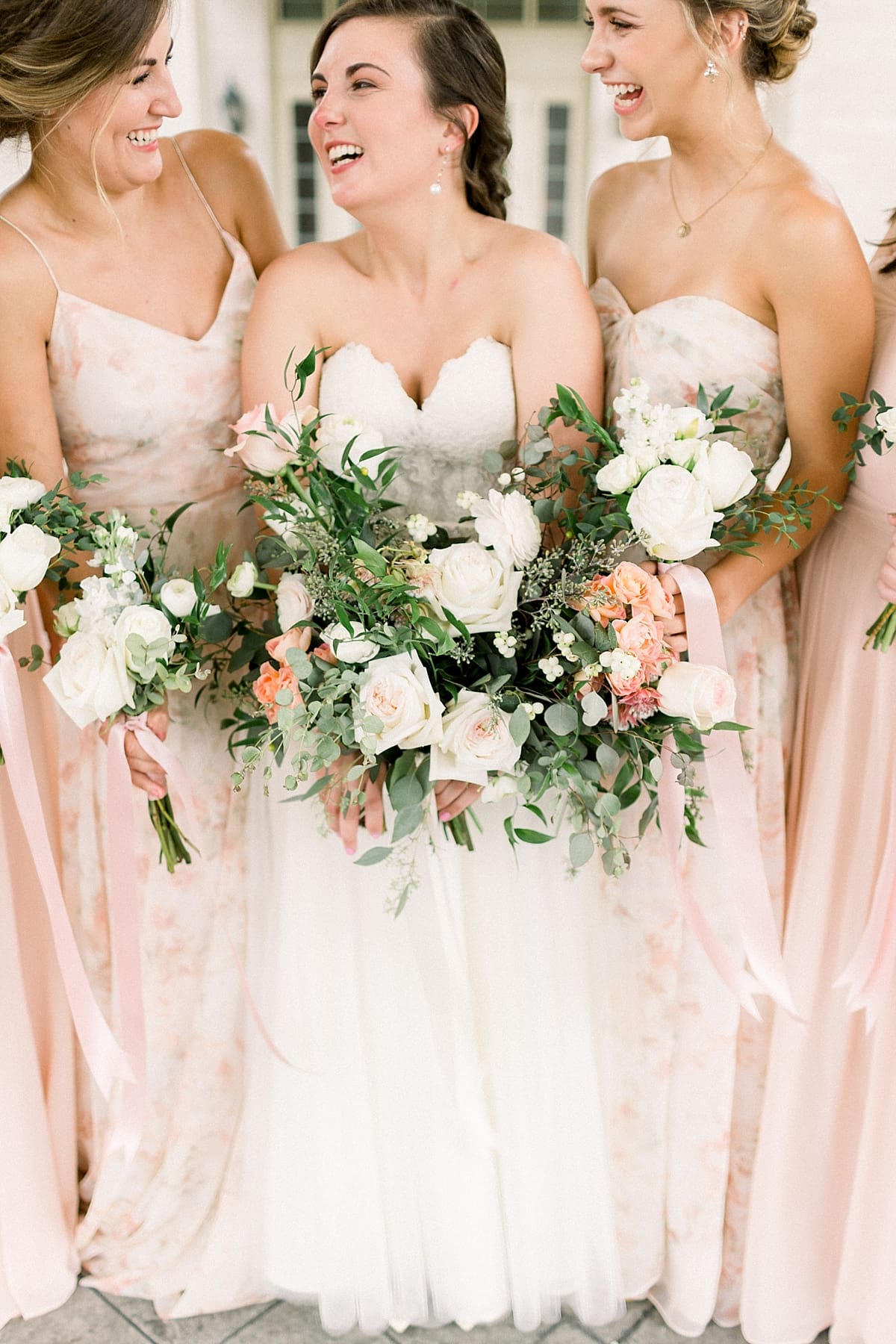 Arielle Peters Photography | Bride and bridesmaids laughing outside at The Bridgewater Club in Carmel, Indiana on wedding day.
