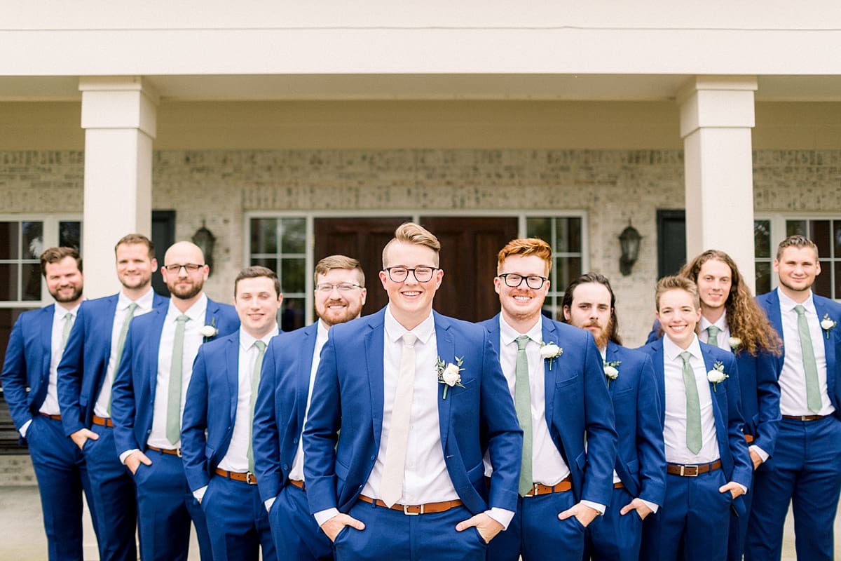 Arielle Peters Photography | Groom and groomsmen smiling with their hands in their pockets outside at The Bridgewater Club in Carmel, Indiana on wedding day.