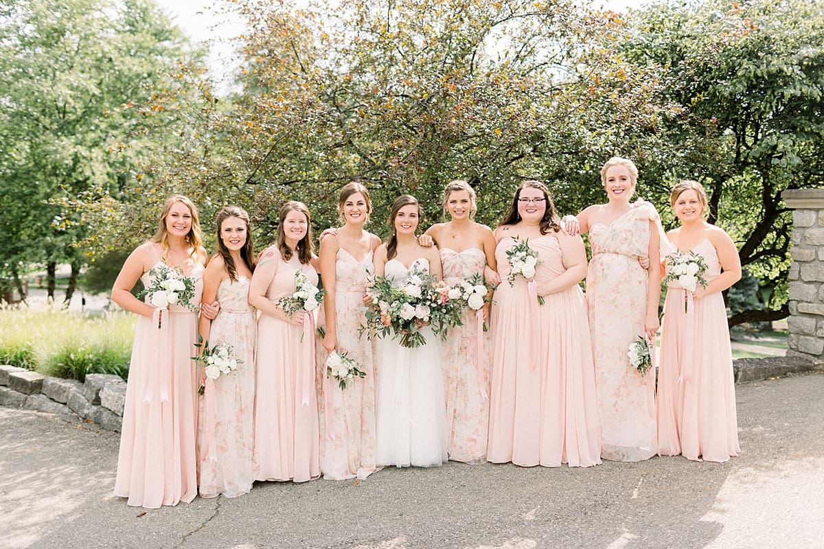Arielle Peters Photography | Bride and bridesmaids smiling outside at The Bridgewater Club in Carmel, Indiana on wedding day.